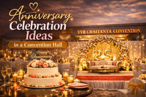 Elegant anniversary celebration setup at VVR Chaitanya Convention Hall with floral stage and cake decoration.